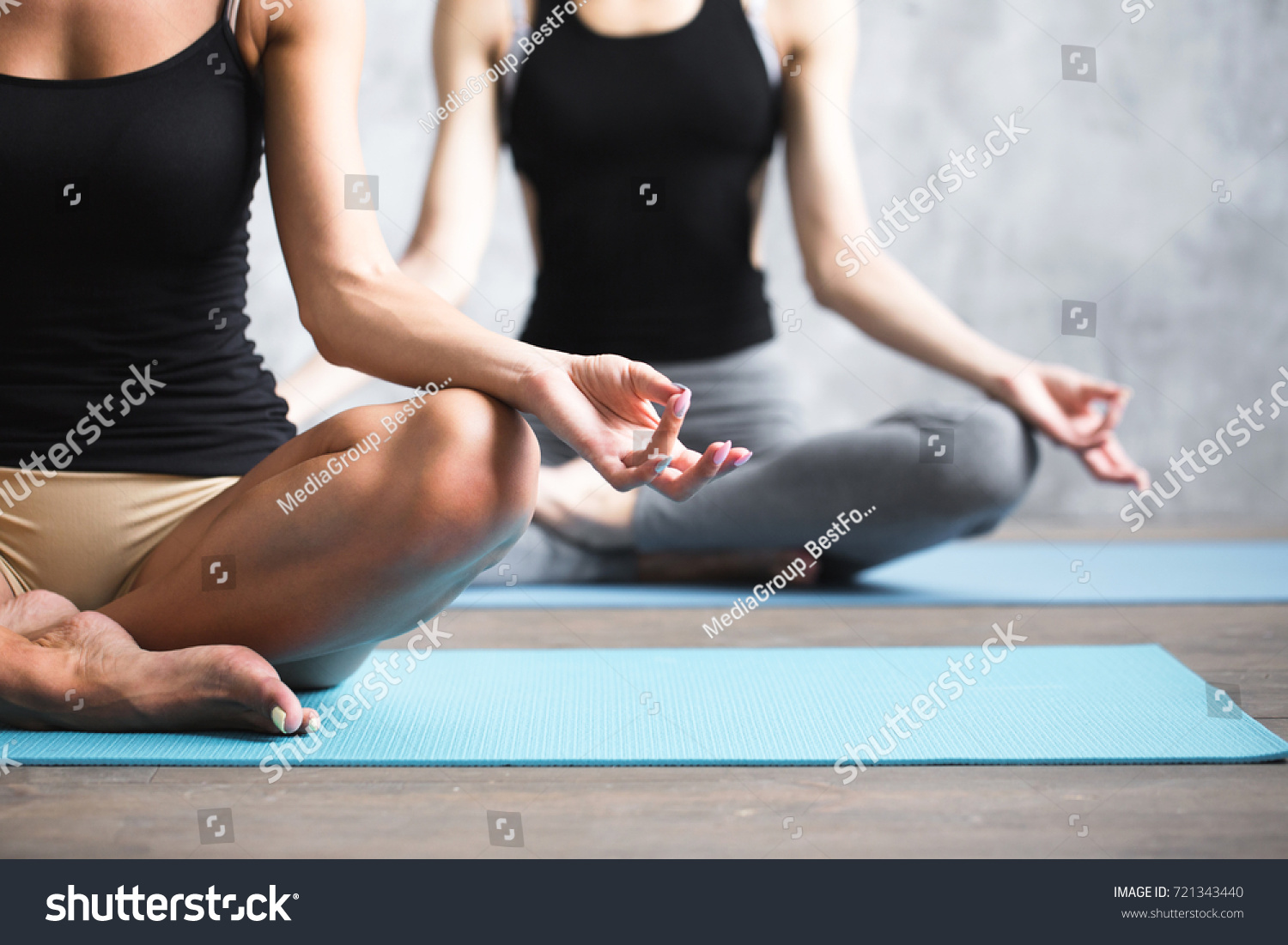 stock-photo-group-people-practicing-yoga-indoors-close-up-hands-in-meditating-gesture-copy-space-721343440